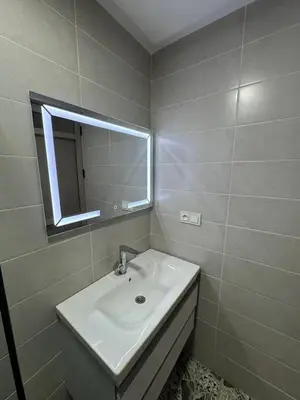 a bathroom with a sink and a mirror at Dar location luxury in Meknès