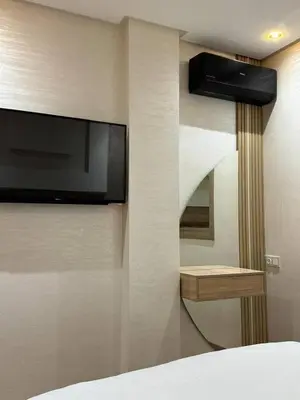 a bedroom with a flat screen tv on a wall at Dar location luxury in Meknès