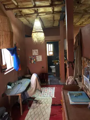 a person laying on a table in a room with a surfboard at Chill and welcoming flat in Tagounite in Tagounite