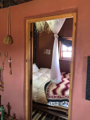 a bedroom with a canopy bed and a window at Chill and welcoming flat in Tagounite in Tagounite
