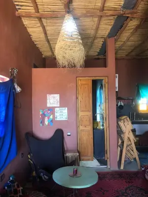 a room with a table and a chandelier at Chill and welcoming flat in Tagounite in Tagounite