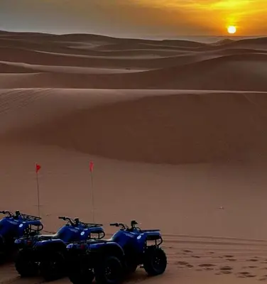 a group of motorcycles parked in the desert at Desert Berber Luxury Camp in Merzouga