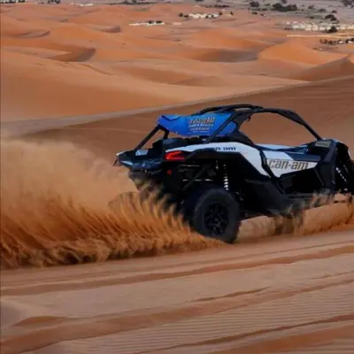 a atv driving through the sand in the desert at Desert Berber Luxury Camp in Merzouga