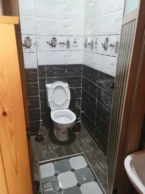 a bathroom with a toilet and a sink at Ourika atlas home in Setti Fatma