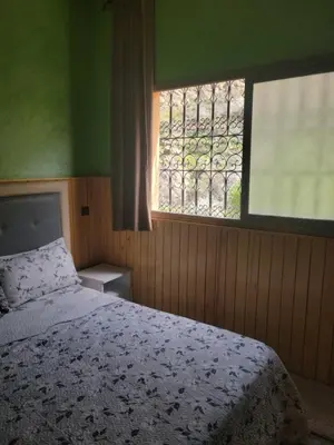 a bedroom with a bed and a window at Ourika atlas home in Setti Fatma