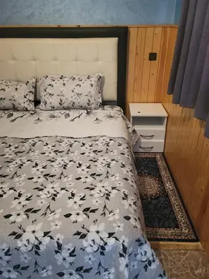a bedroom with a bed with a black and white comforter at Ourika atlas home in Setti Fatma