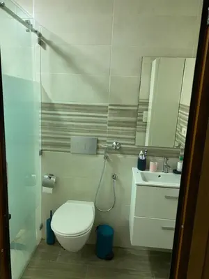 a bathroom with a toilet and a sink and a mirror at Jnane meknes in Meknès