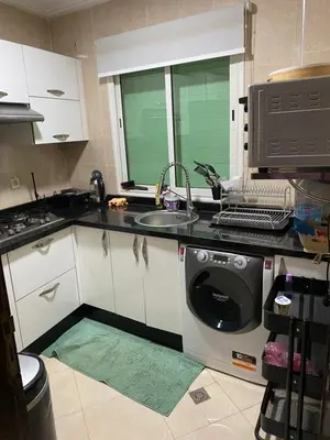 a kitchen with a sink and a washing machine at Jnane meknes in Meknès