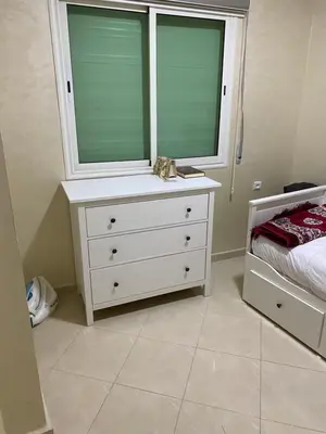 a bedroom with a white dresser and a window at Jnane meknes in Meknès