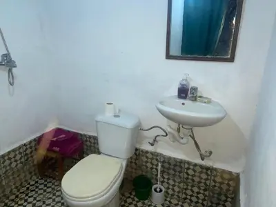 a bathroom with a toilet and a sink at Gite Amani Guest House in Zaouia Hansala