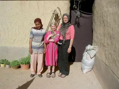 a group of three women standing next to a wall at Mahdi gajli in Ouarzazate