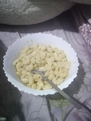 a bowl of macaroni and cheese with a fork in it at Mahdi gajli in Ouarzazate
