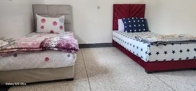 two beds in a room with two beds sidx sidx sidx sidx at Appartement Ritage in Meknès