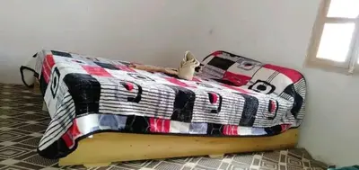 a bed in a room with a bedspread with a stuffed animal on it at gite taghia ahanssal in Taghia