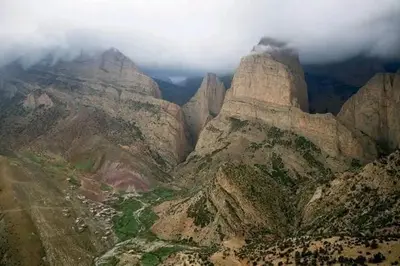 an aerial view of a mountain with clouds on it at gite taghia ahanssal in Taghia