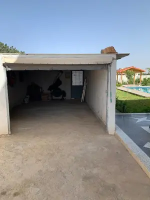 an empty garage with a pool in the background at Al confort in Fès