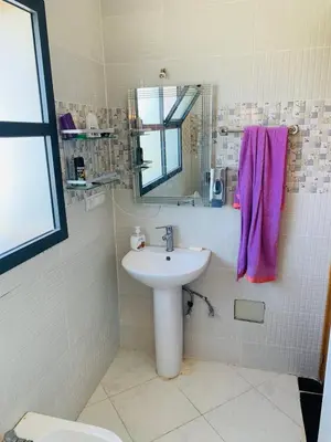 a bathroom with a sink and a mirror at Al confort in Fès