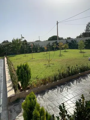 a garden with trees and a grass field at Al confort in Fès
