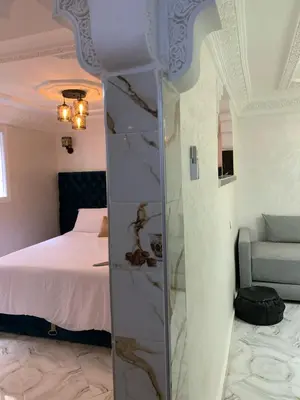 a bedroom with a bed and a mirror in a room at RIAD Jad in Fès