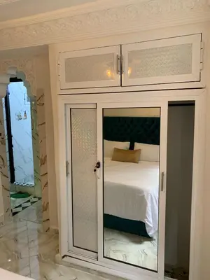 a white cabinet with a bed in a room at RIAD Jad in Fès