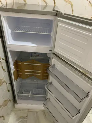 an empty refrigerator with its door open at RIAD Jad in Fès