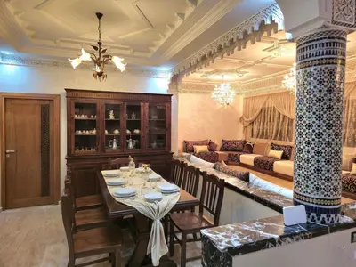 a dining room with a table and a couch at Charming Fassi Stay, 5 min Center in Fès