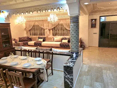 a living room with two tables and a couch at Charming Fassi Stay, 5 min Center in Fès
