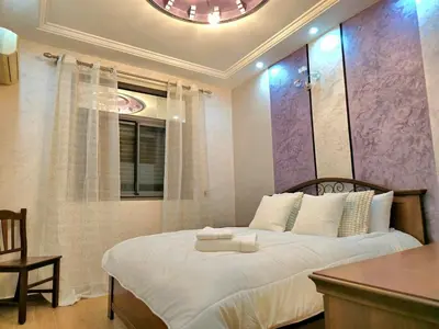 a bedroom with a bed with a table and a chair at Charming Fassi Stay, 5 min Center in Fès