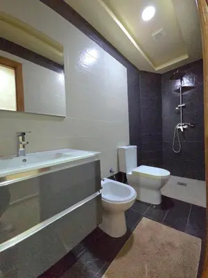 a bathroom with a toilet and a sink and a shower at Charming Fassi Stay, 5 min Center in Fès