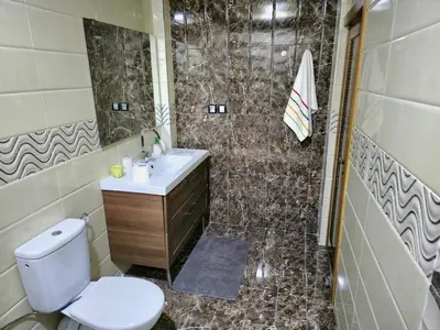 a bathroom with a toilet and a sink and a shower at Charming Fassi Stay, 5 min Center in Fès