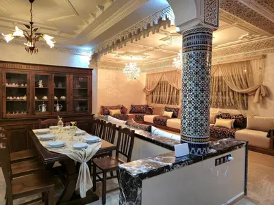 a dining room with a table and a couch at Charming Fassi Stay, 5 min Center in Fès