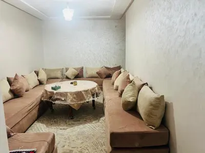 a living room with a couch and a table at حي الامل بني ملال in Beni Mellal