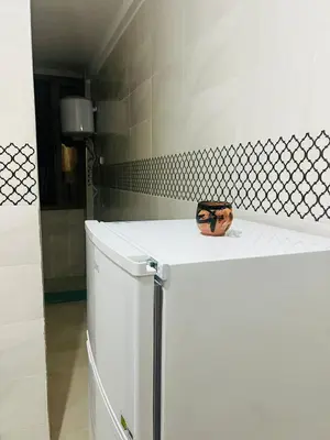 a white refrigerator in a bathroom with a bowl on top at حي الامل بني ملال in Beni Mellal