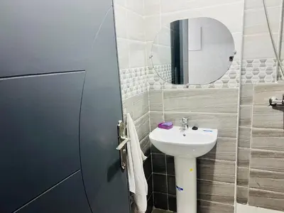 a bathroom with a sink and a mirror at حي الامل بني ملال in Beni Mellal