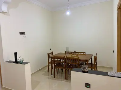 a dining room with a table and chairs at Yahya in Srarhna