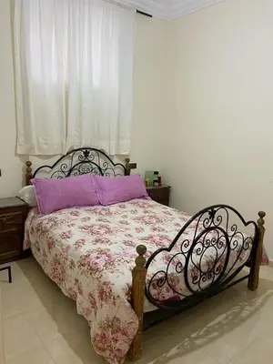 a bedroom with a bed with a purple pillow at Yahya in Srarhna