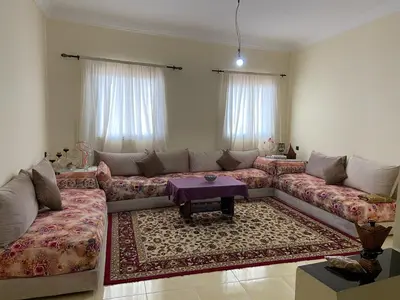 a living room with a couch and a table at Yahya in Srarhna