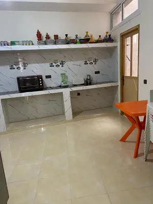 a kitchen with a counter with a counter top at Yahya in Srarhna