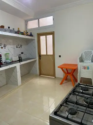 a kitchen with a stove top oven in a room at Yahya in Srarhna