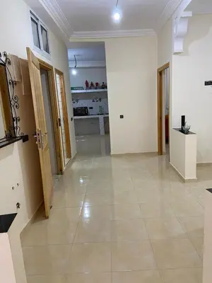 a large room with a tile floor and a hallway at Yahya in Srarhna
