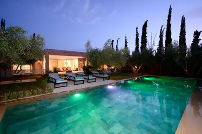 a swimming pool in the backyard of a house at Villa Essalam Marrakech in Marrakech