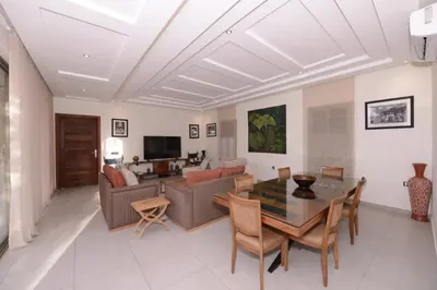 a living room with a table and a couch at Villa Essalam Marrakech in Marrakech