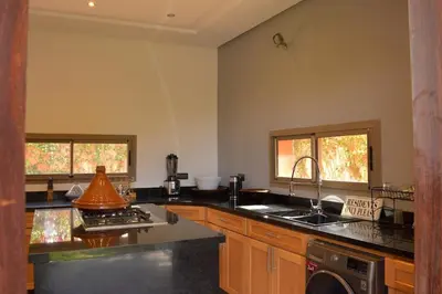 a kitchen with a sink and a stove at Villa Essalam Marrakech in Marrakech