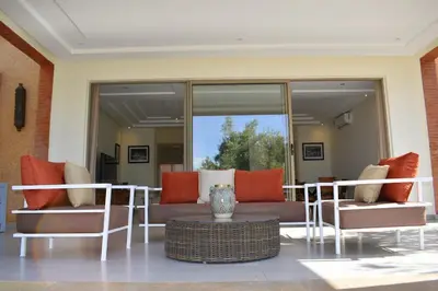 a living room with a couch and some chairs at Villa Essalam Marrakech in Marrakech