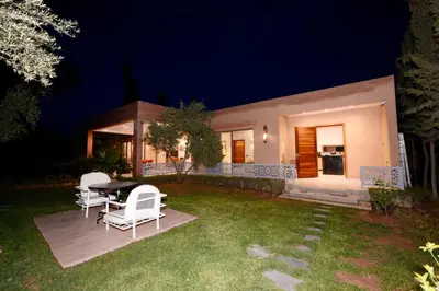 a house with a table and chairs in the yard at Villa Essalam Marrakech in Marrakech