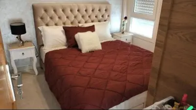 a bedroom with a large bed with a red blanket at Rim in Fès
