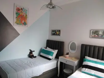 a bedroom with a bed with a teddy bear sitting on it at Rim in Fès