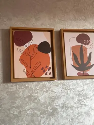 two framed prints of flowers on a wall at Rim in Fès
