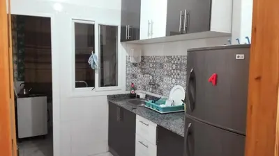 a kitchen with a refrigerator and a sink at Rim in Fès