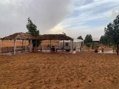 a tent in the middle of a dirt field at Merzouga Stars Luxury Camp in Merzouga